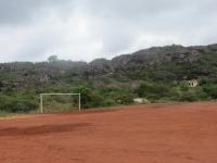 Registro do campo de futebol e rejeitos de antigos garimpos ao lado da casa no início da trilha da Rampa do Caim. Foto: Violeta de Souza Martins, 2021.